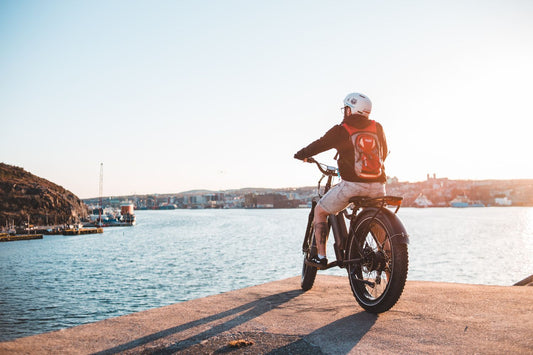 Man on mountain e-bike on dock in sunset